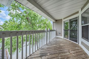 The deck has a view of the trees 