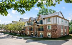Peoria apartment for rent - A large brick building with a white trim and a balcony on the second floork at Timberlane Apartments, Peoria, Illinois