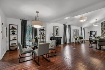 A living room and dining room with a table and chairs