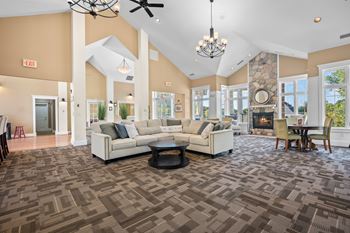 A spacious living room with a patterned carpet and a fireplace