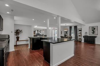 An open kitchen and living room with a large counter top