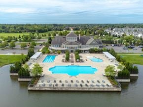 Clinton Twp apartment for rent - an aerial view of a large pool with a building in the backgroundat The Harbours Apartments, Michigan, 48038