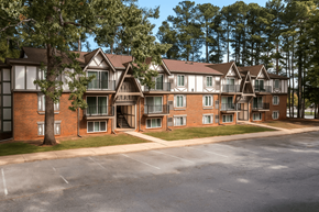 Greenville apartment for rent - A large apartment complex with multiple buildings and a parking lot in front.