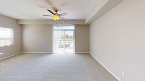La Vista apartment for rent - an enlarged living room with a ceiling fan and a windowat Andover Pointe Apartment Homes, La Vista, 68138
