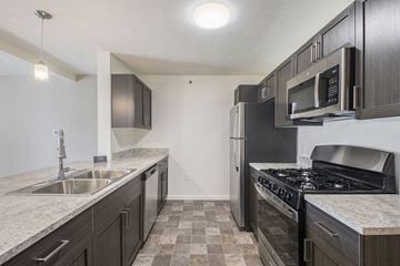 La Vista apartment for rent - a kitchen with stainless steel appliances and marble counter tops