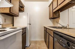 Miamisburg apartment for rent - A kitchen with a white stove and a white refrigerator