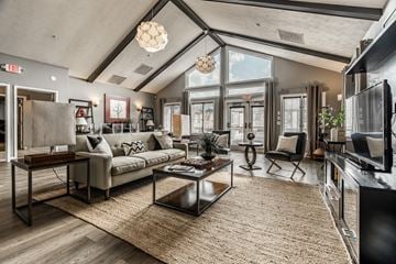 Miamisburg apartment for rent - A modern living room with a large couch and a coffee table.