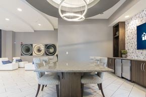 Carmel apartment for rent - a dining space with a table chairs and TV at Avant Apartments in Carmel, IN