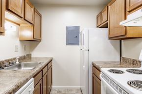 Indianapolis apartment for rent - A kitchen with a white refrigerator and a stove top oven