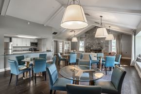 Lafayette apartment for rent - A modern dining room with a glass table surrounded by blue chairs