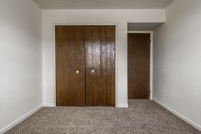 Lafayette apartment for rent - a bedroom with two closet doors and a carpet floor at Bay Pointe Apartments in Lafayette, IN 47909