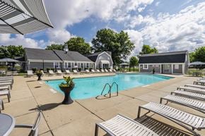 Lafayette apartment for rent - A pool area with sun loungers and a building in the background