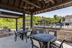 Fishers apartment for rent - an outdoor patio with tables and chairs and a pool at Bella Vista Apartments, Fishers, IN, 46038