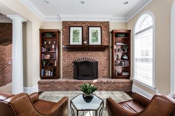Merrillville apartment for rent - a living room with a brick fireplace and leather furniture