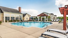 Merrillville apartment for rent - A pool area with sun loungers and a building in the background