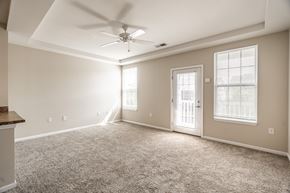 Merrillville apartment for rent - A spacious room with a ceiling fan and carpeted floor