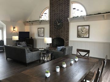 South Bend apartment for rent - a living room with a wooden table and a brick fireplace