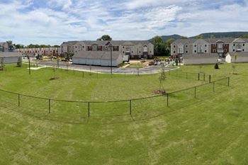 An aerial view of a fenced in dog park at chase creek apartment homes in alabama