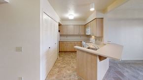 Bellevue apartment for rent - a kitchen with wooden cabinets and white appliances at Colonial Pointe at Fairview Apartments, Bellevue, NE