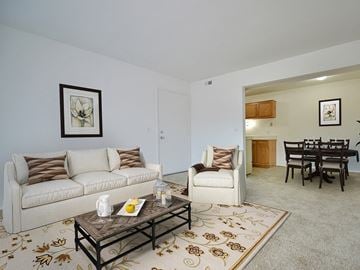 Davison apartment for rent - a living room with a couch and a chair and a dining room