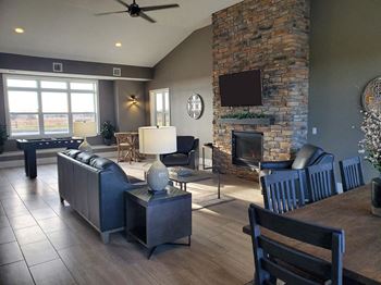 Luxurious clubhouse with hardwood flooring and fireplace