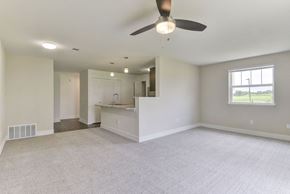 Rogers apartment for rent - A spacious living and dining room with a ceiling fan and a window at Dodson Pointe Apartment Homes, Rogers, AR