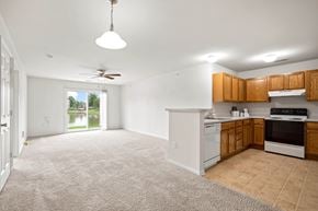 Grand Chute apartment for rent - A kitchen with white appliances and wooden cabinets at Towne Lakes Apartments, Grand Chute