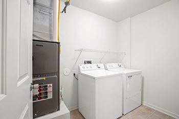 A small laundry room with a washer and dryer