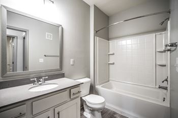 A white toilet sits next to a sink in a bathroom