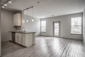 A spacious kitchen with wooden floors and a large island
