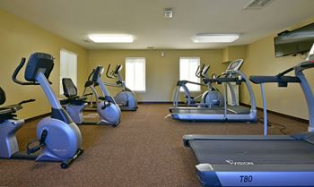 A gym with cardio equipment and exercise bikes