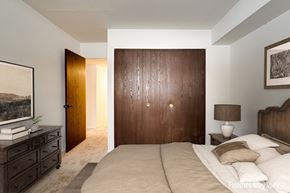 Rockford apartment for rent - A bedroom with a large bed, a dresser, and a painting on the wall at Beacon Hill and Great Oaks Apartments, Rockford, Illinois
