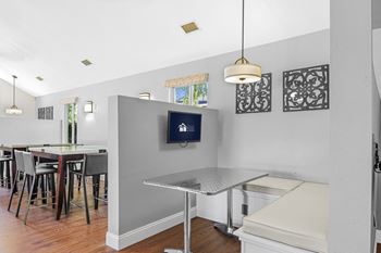 A kitchen with a table and chairs.