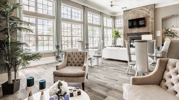 Columbus apartment for rent - a living room with large windows and a table with chairs