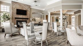 Columbus apartment for rent - a dining room with a table and chairs and a brick fireplace at The Avenue at Polaris Apartments, Columbus, OH