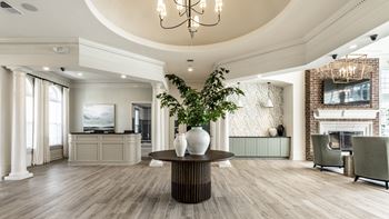 Clubhouse/leasing center with a coffee bar fireplace and a round table