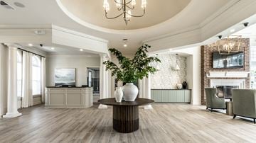 Carmel apartment for rent - a living room with a fireplace and a table with a plant