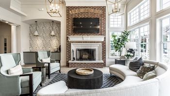 Resident lounge with couch chairs tv and fireplace 