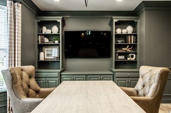 Business center with conference table and large tv