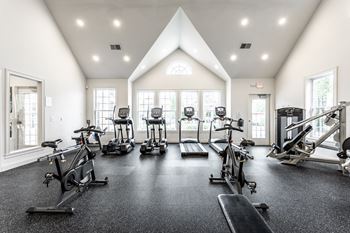 Cardio and resistance gym with workout equipment and windows 