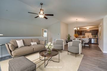 Columbia townhouse for rent - a living room with couches and chairs and a ceiling fan