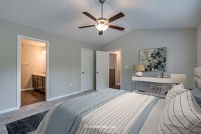 Columbia townhouse for rent - a bedroom with a large bed and a ceiling fan  at Killian Lakes Apartments and Townhomes, South Carolina