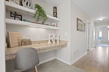 A home office with a desk and shelves