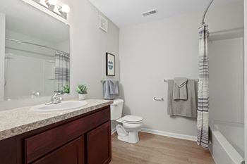 A bathroom with a toilet sink and bathtub
