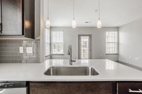 Columbus apartment for rent - a kitchen with white counter tops and a sink at The Avenue at Polaris Apartments, Columbus, OH