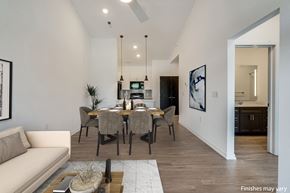 Troy apartment for rent - a dining area with a table and chairs and a kitchen in the background at Uptown Square Apartments, Michigan