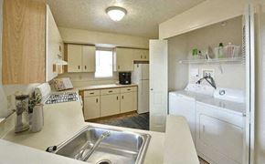 Grand Blanc apartment for rent - a kitchen with a sink and a washing machine at Heatherwood Apartments, Grand Blanc