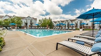 A pool surrounded by sun loungers and umbrellas