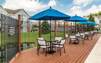 A wooden deck with chairs and umbrellas