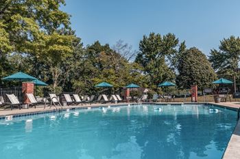 A swimming pool with chairs and umbrellas at the resort